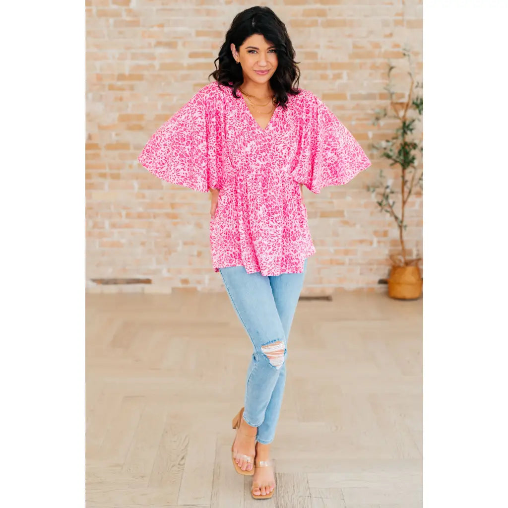 Step out in our Dreamer Peplum Top Pink Leopard! Featuring a playful v - neckline flowy dolman sleeves and flattering