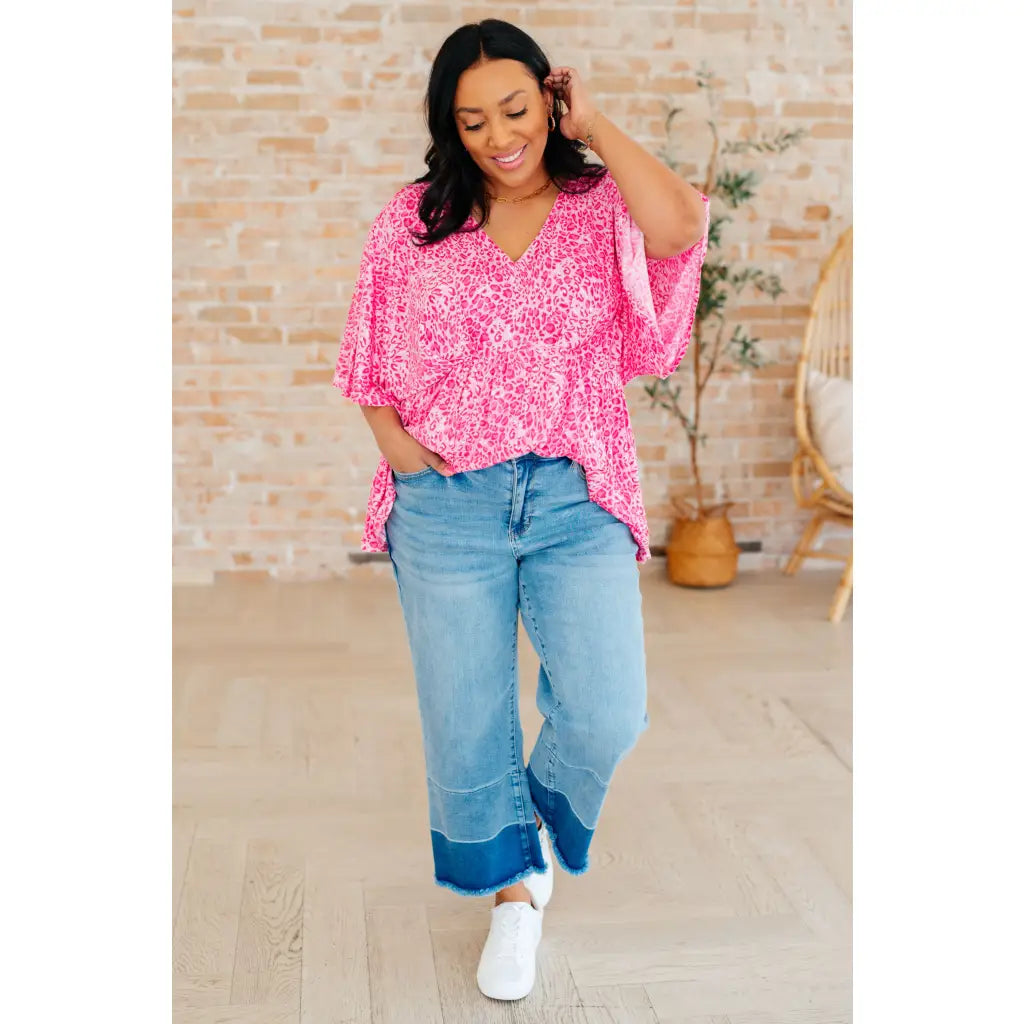 Step out in our Dreamer Peplum Top Pink Leopard! Featuring a playful v - neckline flowy dolman sleeves and flattering