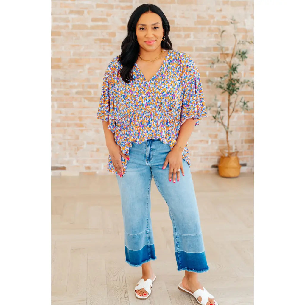 Unleash your inner dreamer with our Dreamer Peplum Top in Purple Retro Ditsy Floral! Featuring a playful v-neckline