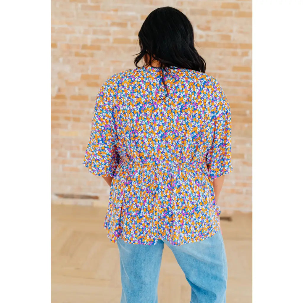 Unleash your inner dreamer with our Dreamer Peplum Top in Purple Retro Ditsy Floral! Featuring a playful v neckline