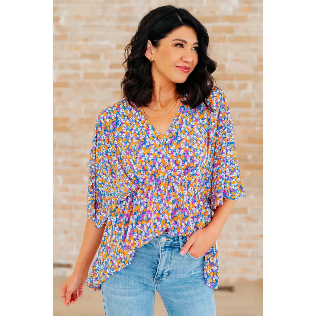 Unleash your inner dreamer with our Dreamer Peplum Top in Purple Retro Ditsy Floral! Featuring a playful v neckline