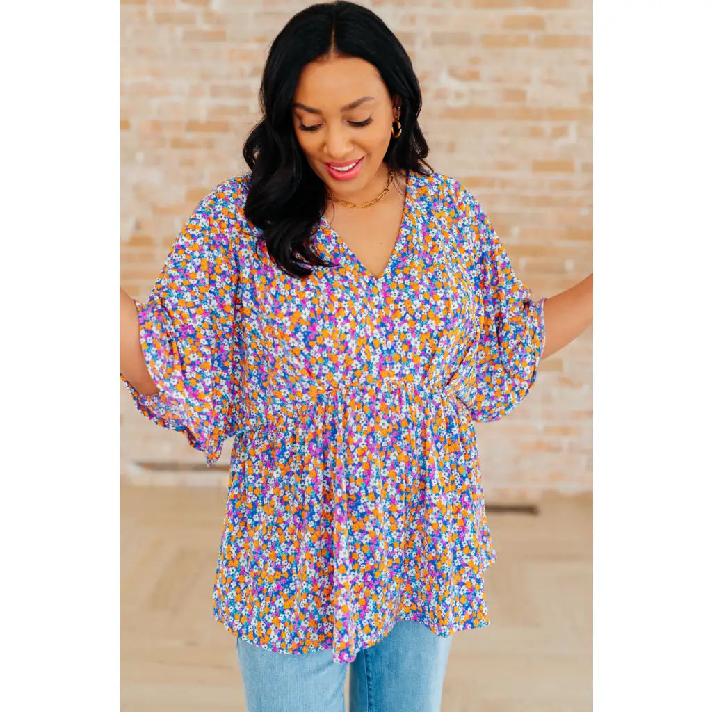 Unleash your inner dreamer with our Dreamer Peplum Top in Purple Retro Ditsy Floral! Featuring a playful v neckline