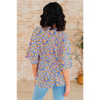 Unleash your inner dreamer with our Dreamer Peplum Top in Purple Retro Ditsy Floral! Featuring a playful v-neckline