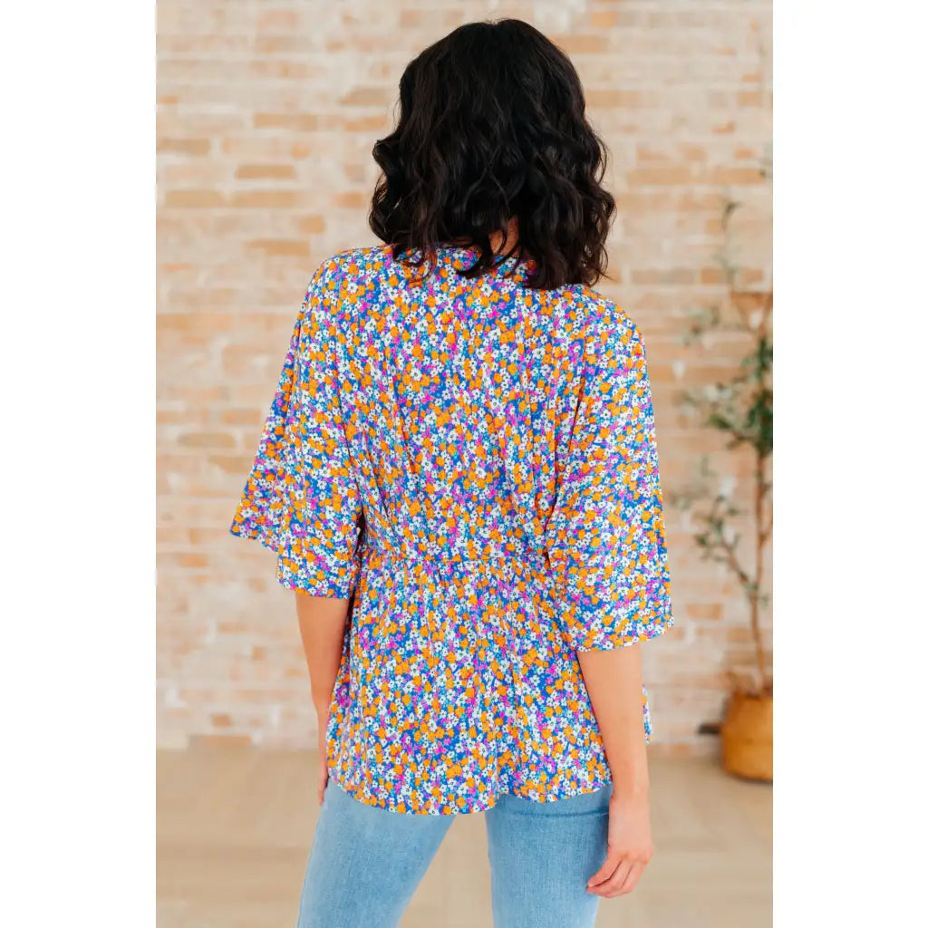 Unleash your inner dreamer with our Dreamer Peplum Top in Purple Retro Ditsy Floral! Featuring a playful v neckline