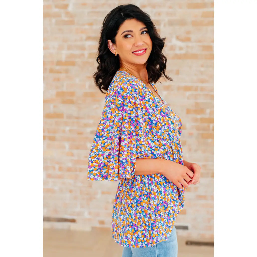 Unleash your inner dreamer with our Dreamer Peplum Top in Purple Retro Ditsy Floral! Featuring a playful v neckline
