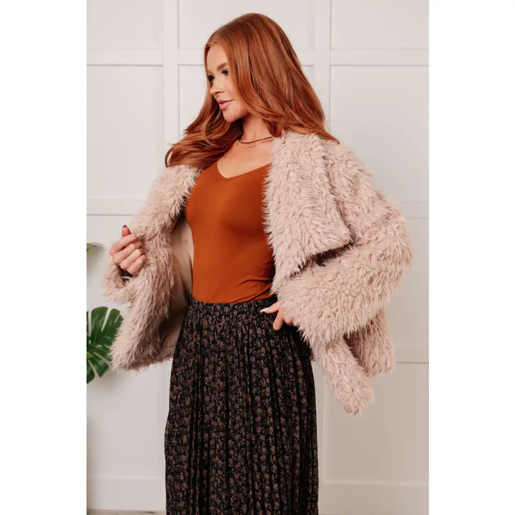 Our Dreaming in Blush Faux Fur Coat will make you shine on the dance floor or out town! Its shaggy faux lambs fur