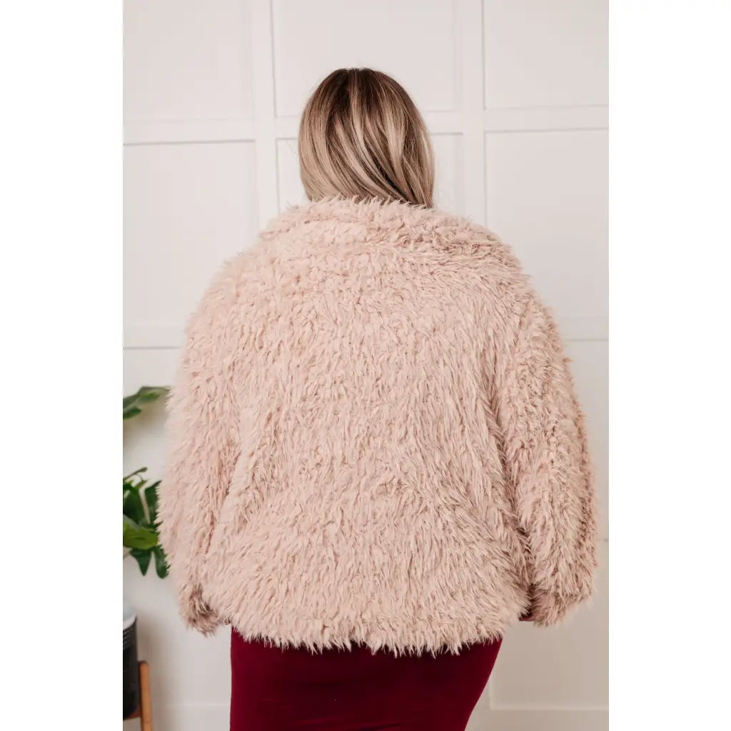 Our Dreaming in Blush Faux Fur Coat will make you shine on the dance floor or out town! Its shaggy faux lambs fur