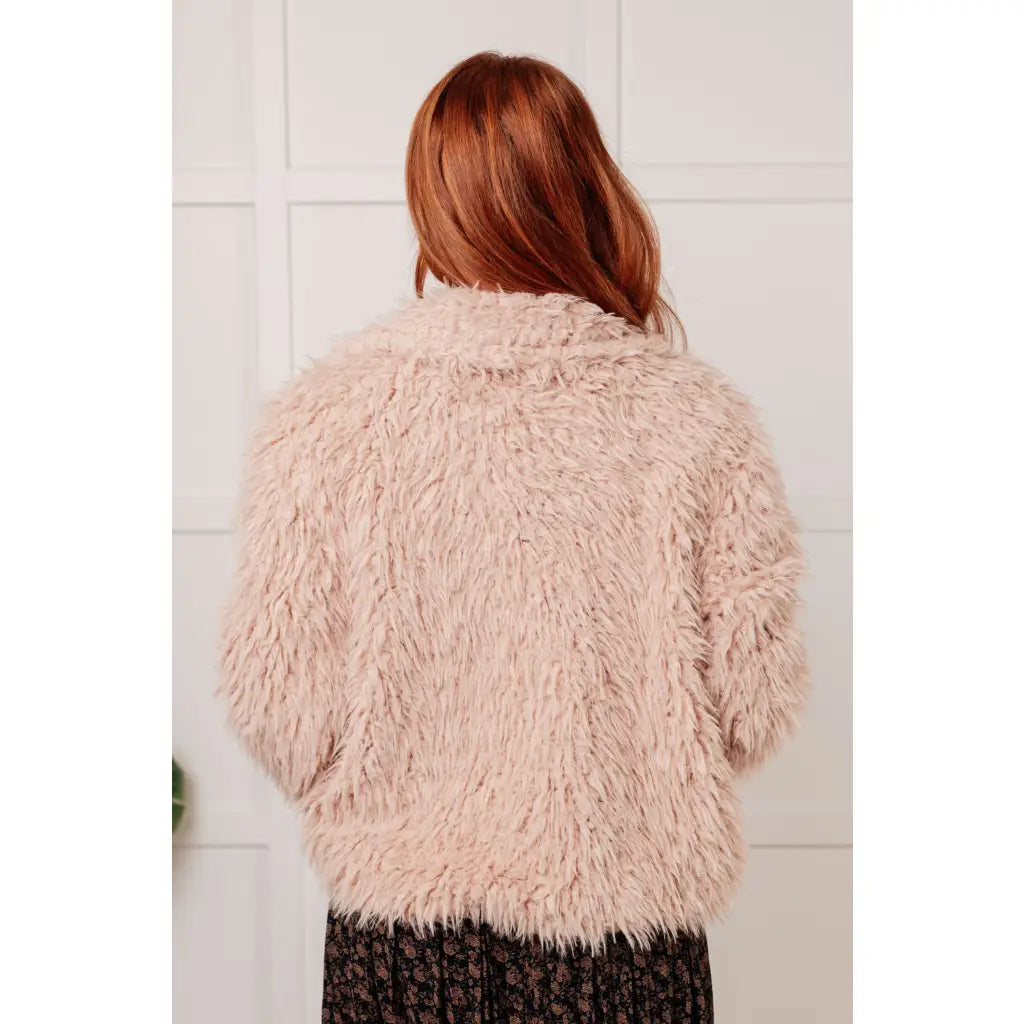 Our Dreaming in Blush Faux Fur Coat will make you shine on the dance floor or out town! Its shaggy faux lambs fur