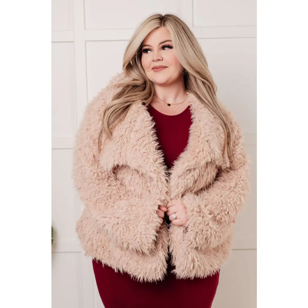 Our Dreaming in Blush Faux Fur Coat will make you shine on the dance floor or out town! Its shaggy faux lambs fur