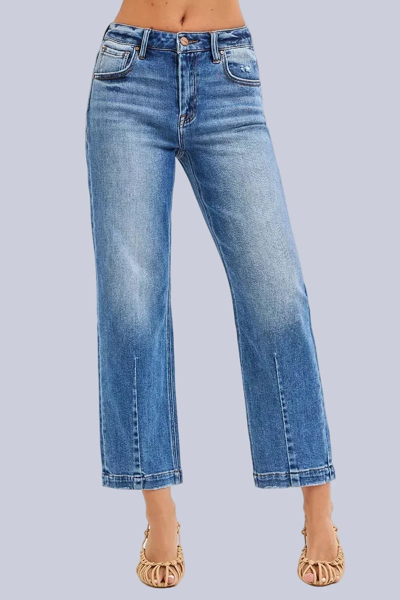 Model wearing Café Chic High Rise Cropped Boyfriend RISEN Jeans in a medium wash with a relaxed cropped boyfriend fit.