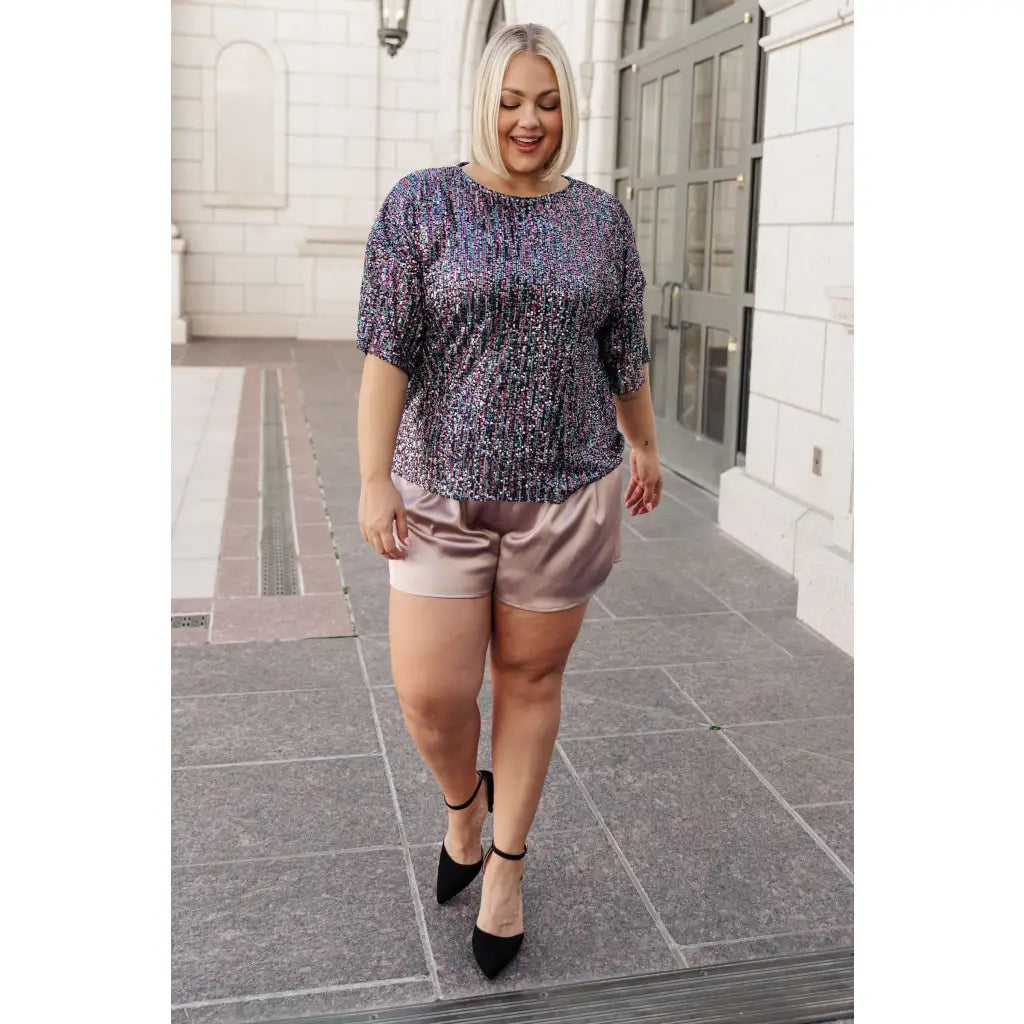 This beautiful Evening of Stars Sequin Top will shine all night with its jewel toned sequin mesh and relaxed fit.