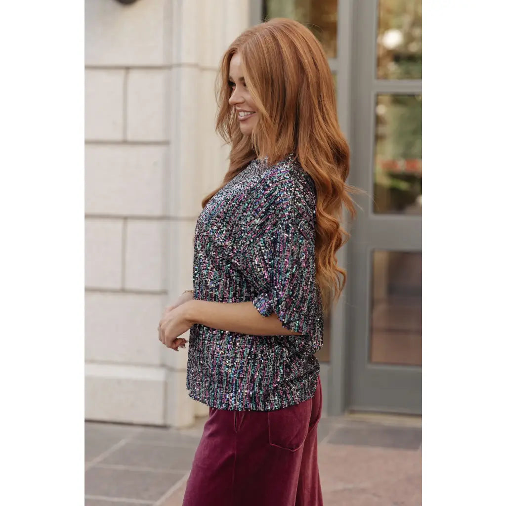This beautiful Evening of Stars Sequin Top will shine all night with its jewel toned sequin mesh and relaxed fit.
