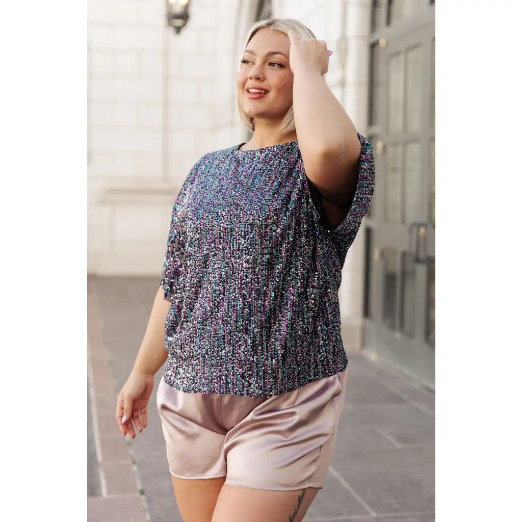 This beautiful Evening of Stars Sequin Top will shine all night with its jewel toned sequin mesh and relaxed fit.
