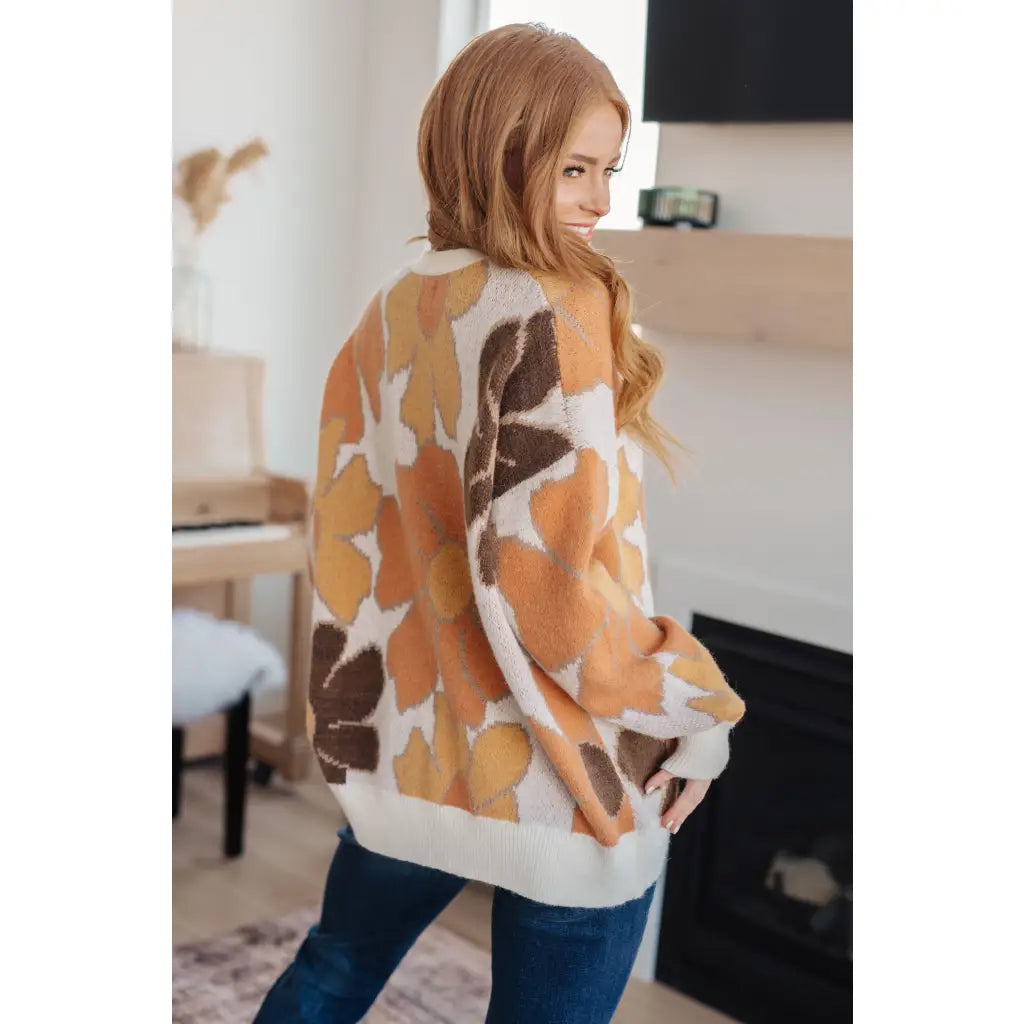 Our Exquisitely Fall Floral Cardigan is a retro mod floral oversized grandpa cardigan featuring an eye-catching large