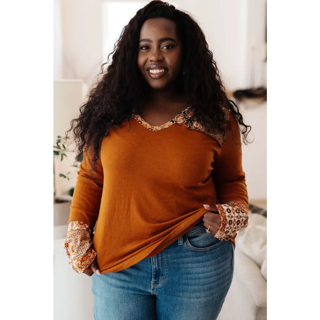 Our Fall Floral Mixed Print Hoodie features a rust colored brushed knit with patterned bulgari accents design.