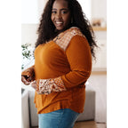 Our Fall Floral Mixed Print Hoodie features a rust colored brushed knit with patterned bulgari accents design.