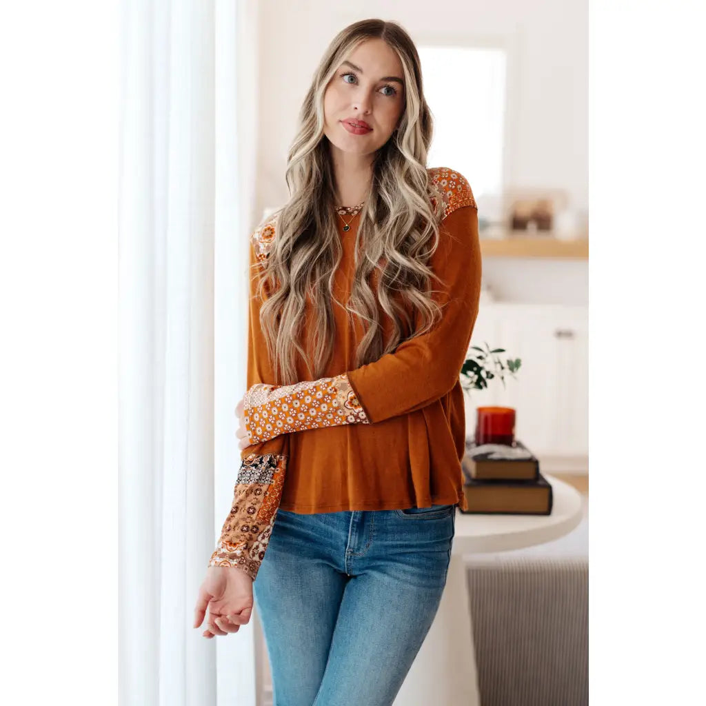 Our Fall Floral Mixed Print Hoodie features a rust colored brushed knit with patterned bulgari accents design.