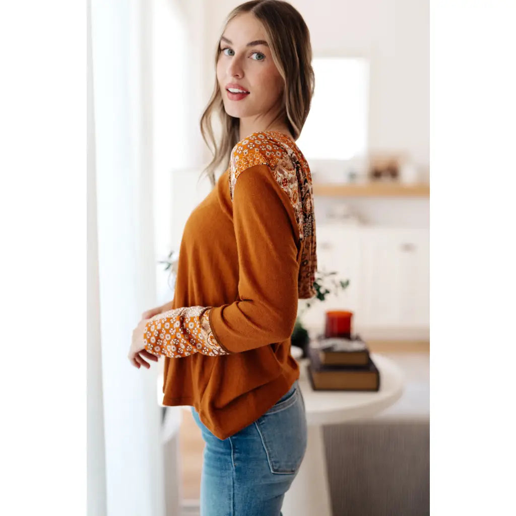 Our Fall Floral Mixed Print Hoodie features a rust colored brushed knit with patterned bulgari accents design.