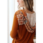 Our Fall Floral Mixed Print Hoodie features a rust colored brushed knit with patterned bulgari accents design.