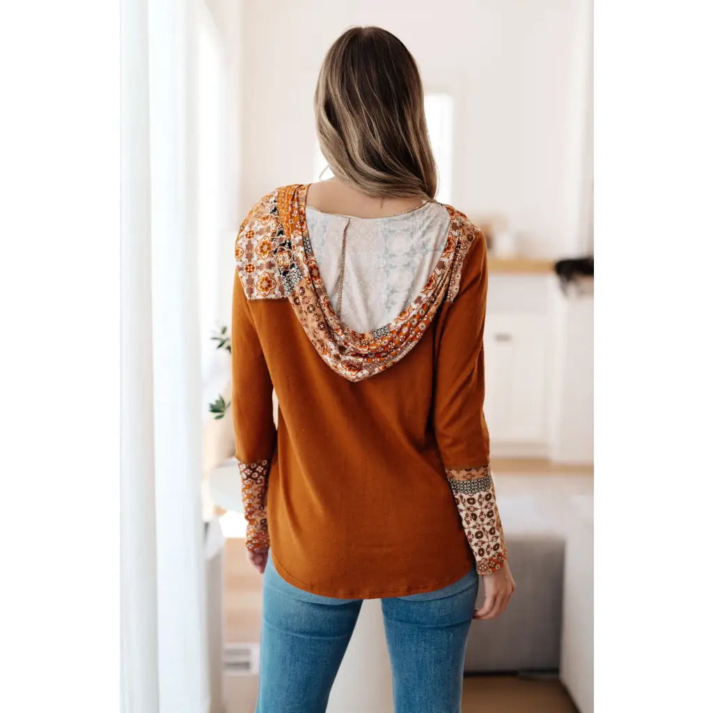 Our Fall Floral Mixed Print Hoodie features a rust colored brushed knit with patterned bulgari accents design.