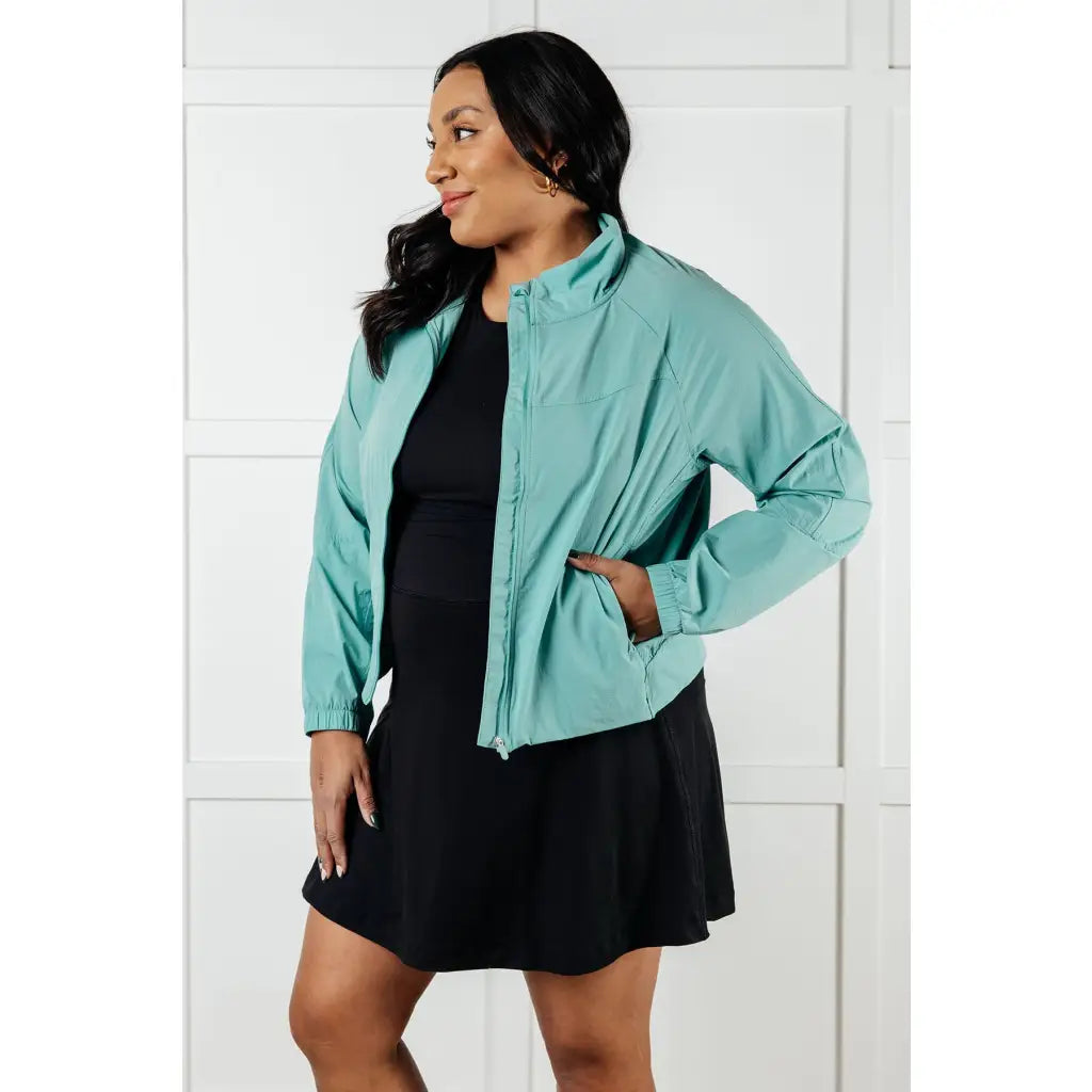Keep your serve stylish with our Fit Happens Nylon Tennis Jacket in Teal. The high neckline and bubble gathered detail