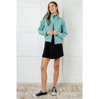 Keep your serve stylish with our Fit Happens Nylon Tennis Jacket in Teal. The high neckline and bubble gathered detail