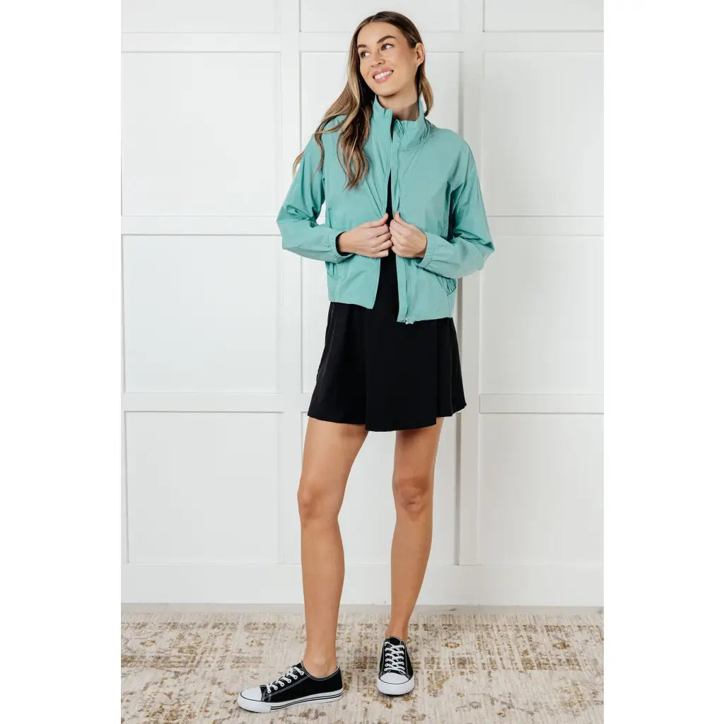 Keep your serve stylish with our Fit Happens Nylon Tennis Jacket in Teal. The high neckline and bubble gathered detail