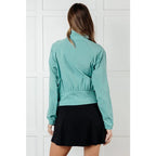 Keep your serve stylish with our Fit Happens Nylon Tennis Jacket in Teal. The high neckline and bubble gathered detail