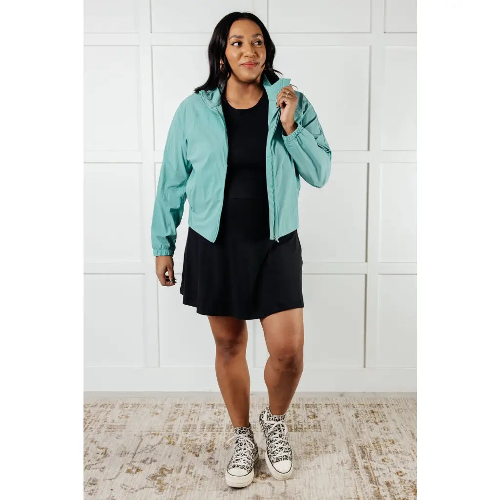 Keep your serve stylish with our Fit Happens Nylon Tennis Jacket in Teal. The high neckline and bubble gathered detail