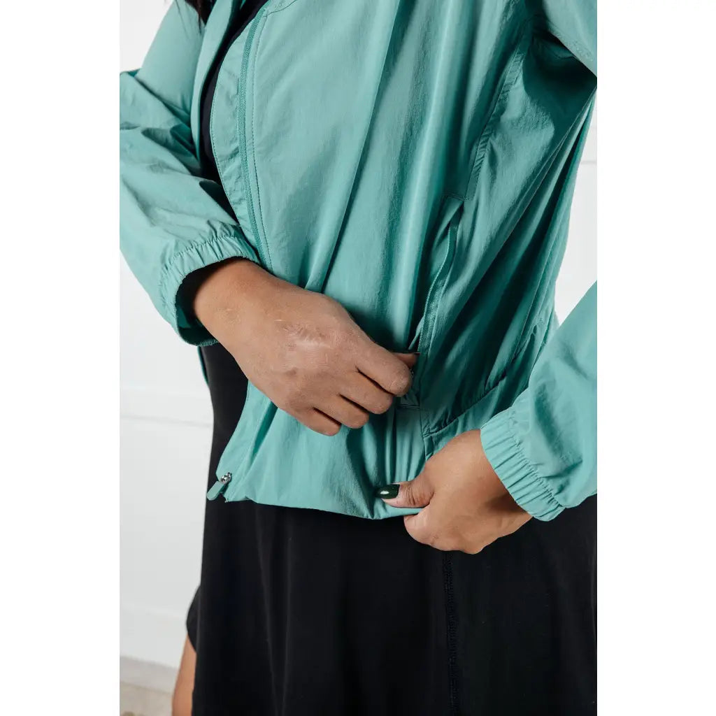 Keep your serve stylish with our Fit Happens Nylon Tennis Jacket in Teal. The high neckline and bubble gathered detail