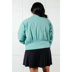 Keep your serve stylish with our Fit Happens Nylon Tennis Jacket in Teal. The high neckline and bubble gathered detail