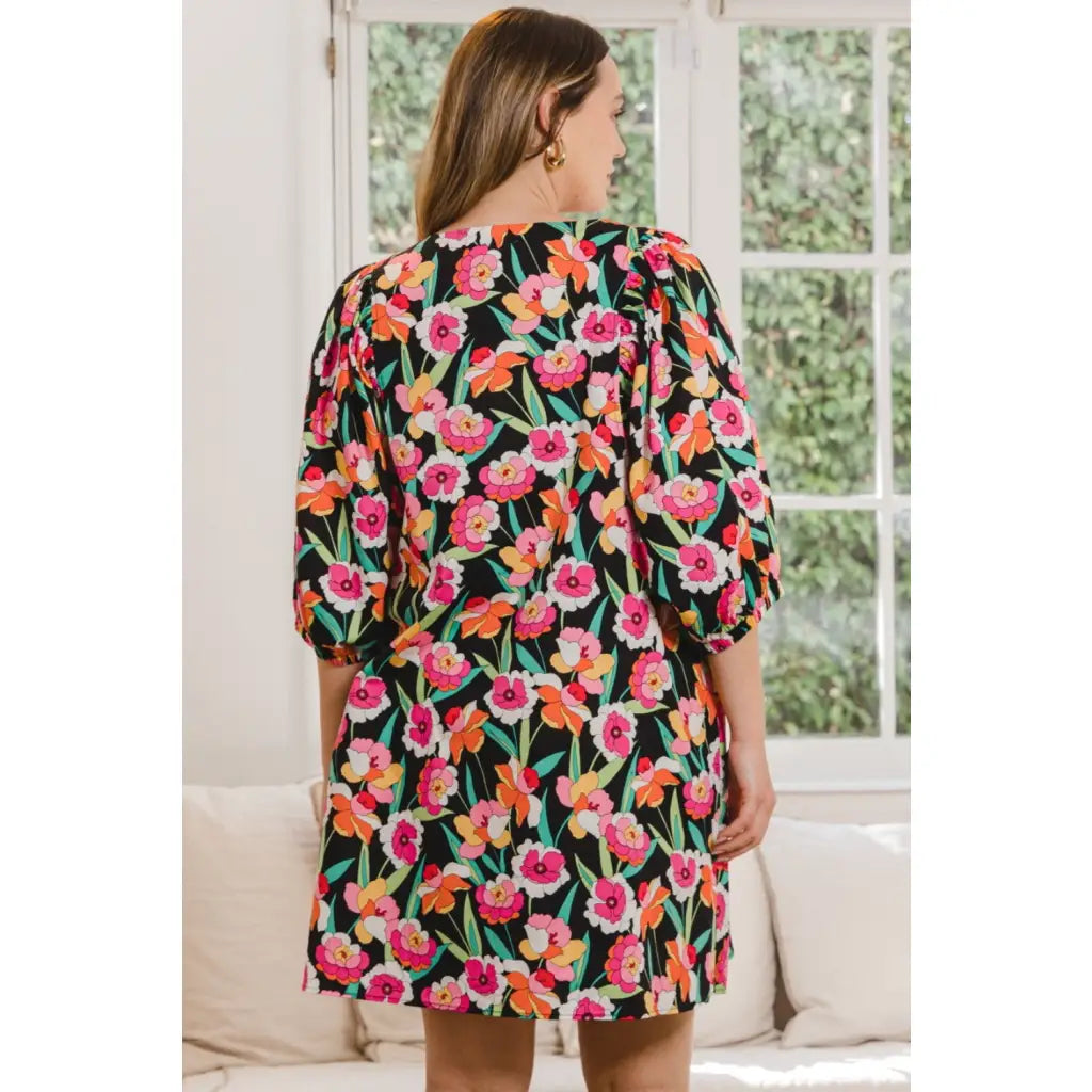 Our Floral Puff Sleeve Mini Dress exudes a feminine vibe with its delicate floral pattern on black background