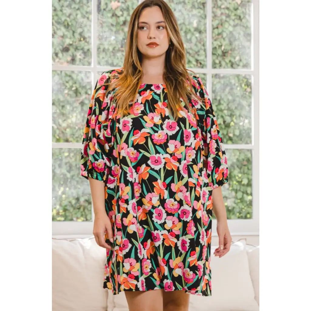 Our Floral Puff Sleeve Mini Dress exudes a feminine vibe with its delicate floral pattern on black background