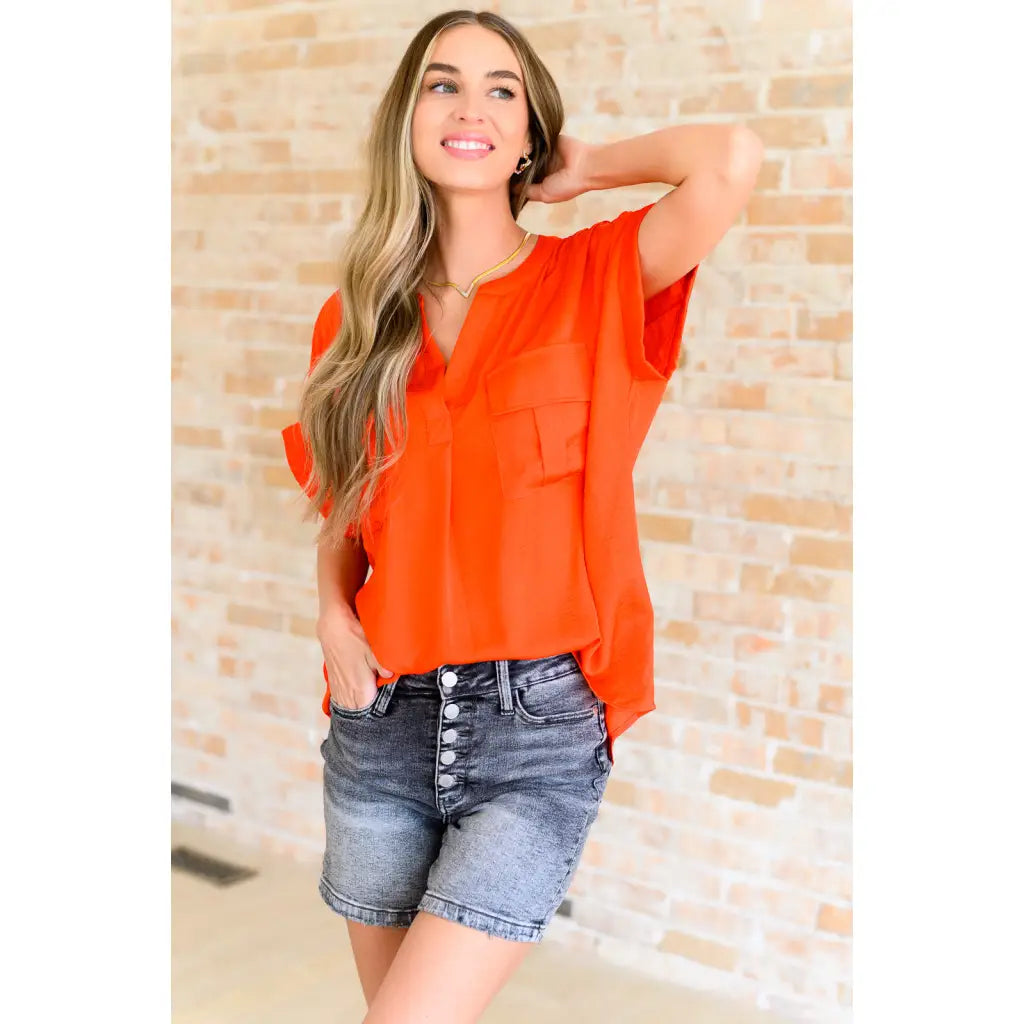 Bold and fun blouse in tomato red with flap pockets cuffed sleeves. A lightweight go-to for regular curvy or plus