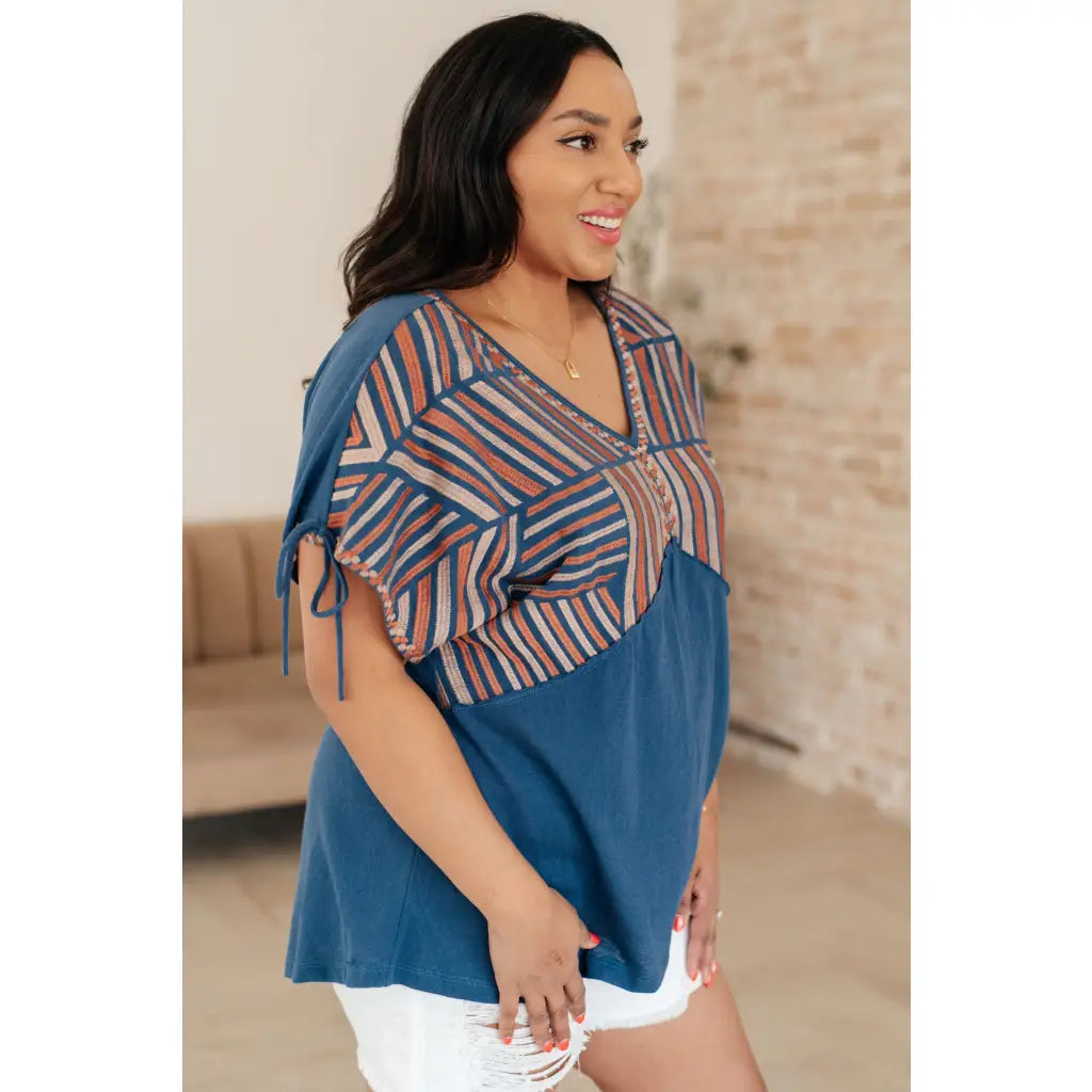 Get ready to strike a stylish pose with our Greece Lightning V Neck Blouse! Made from comfortable jersey knit