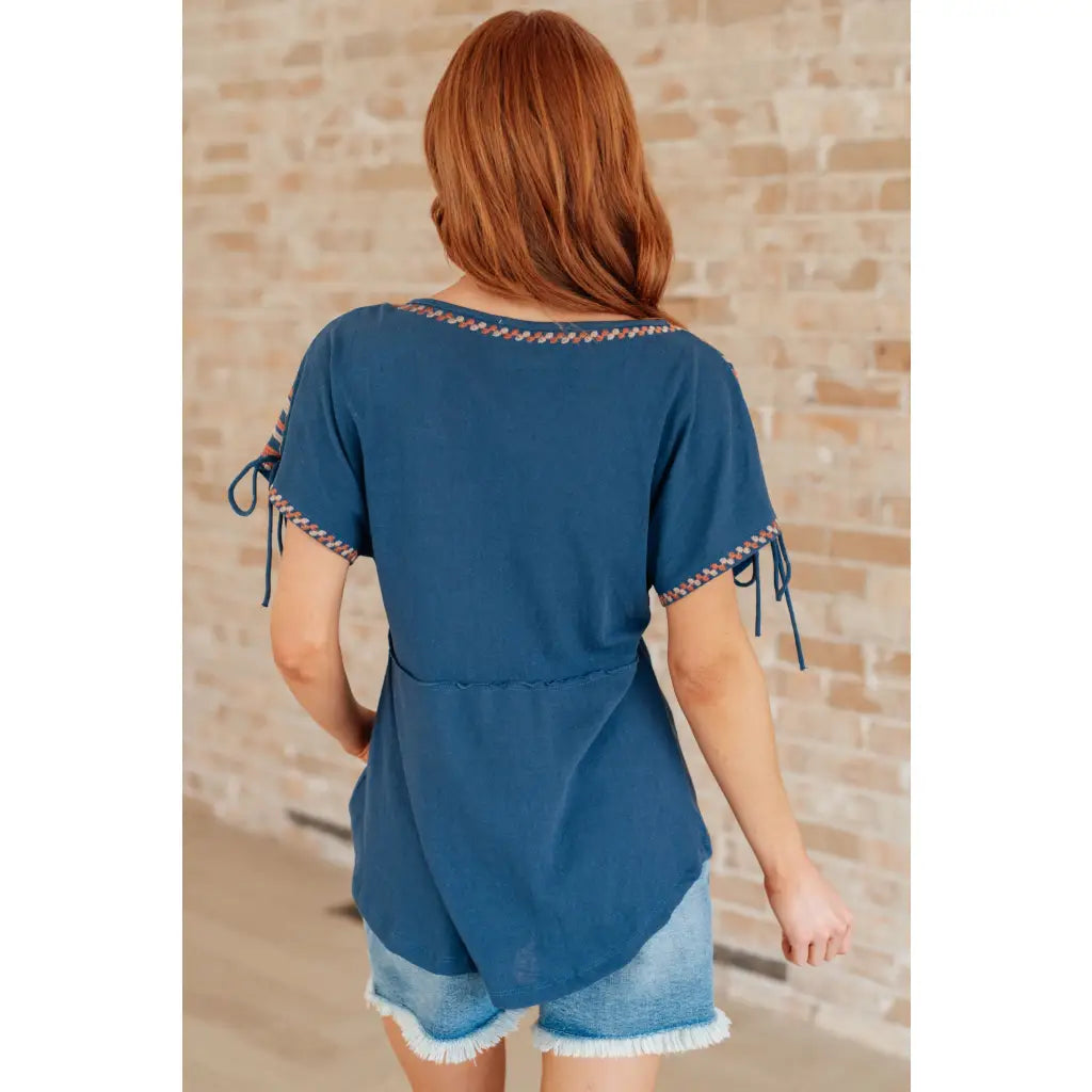 Get ready to strike a stylish pose with our Greece Lightning V Neck Blouse! Made from comfortable jersey knit
