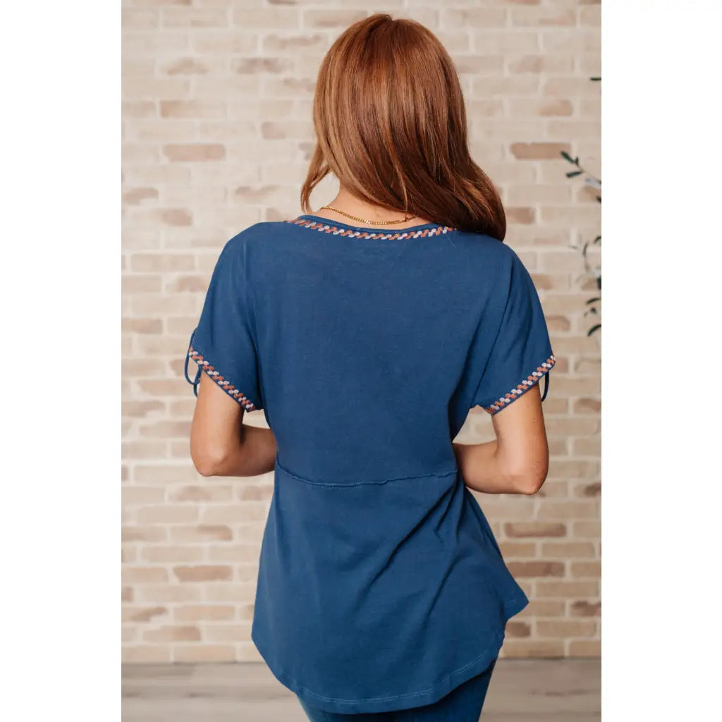 Get ready to strike a stylish pose with our Greece Lightning V Neck Blouse! Made from comfortable jersey knit