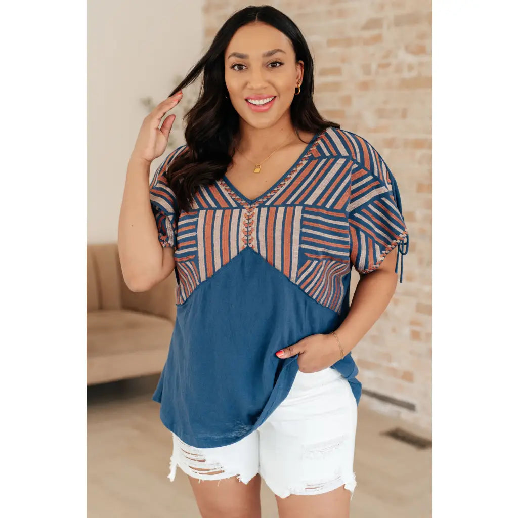 Get ready to strike a stylish pose with our Greece Lightning V Neck Blouse! Made from comfortable jersey knit
