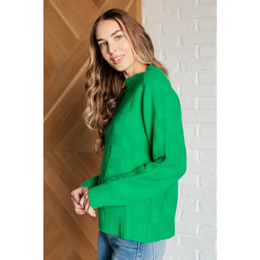 Our Green on Checked Sweater is a playful pullover made with cozy knit material. It features round ribbed neckline long