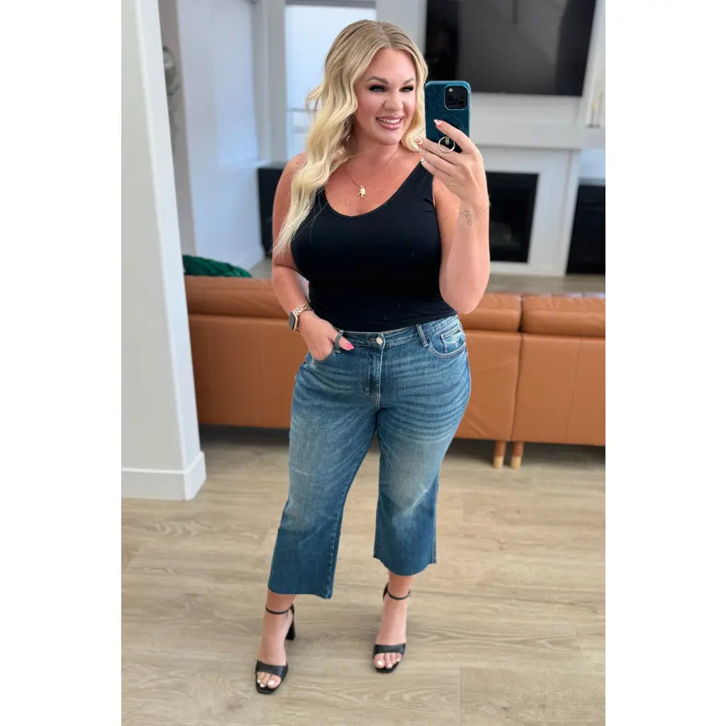 Discover effortless style with our Hayes High Rise Wide Leg Crop Jeans. This medium wash 4-way stretch denim is cut