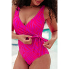 Bold neon animal print one-piece swimsuit with wrap tie plunging neckline and cheeky fit. Perfect plus friendly