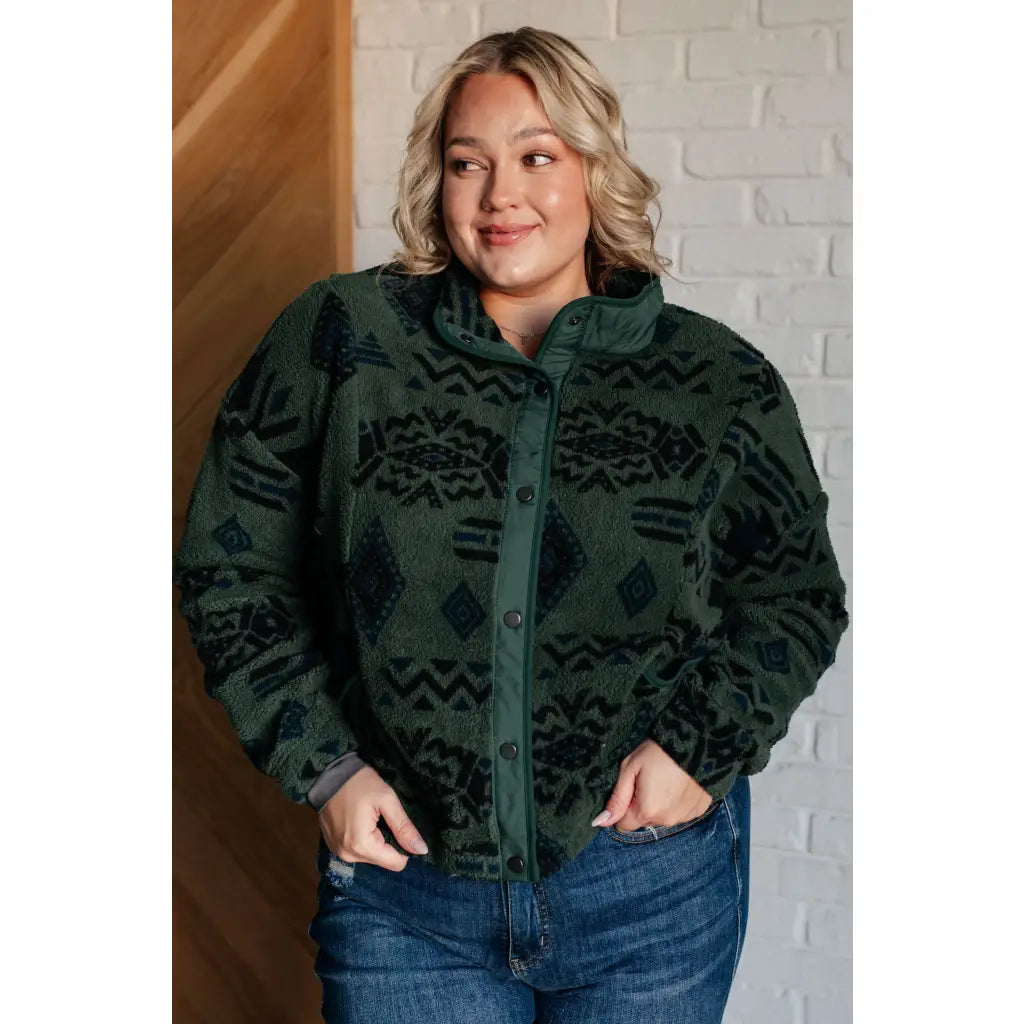 Our High Perspective Geometric Fleece Jacket! Made with green and black soft polar fleece featuring a snap front