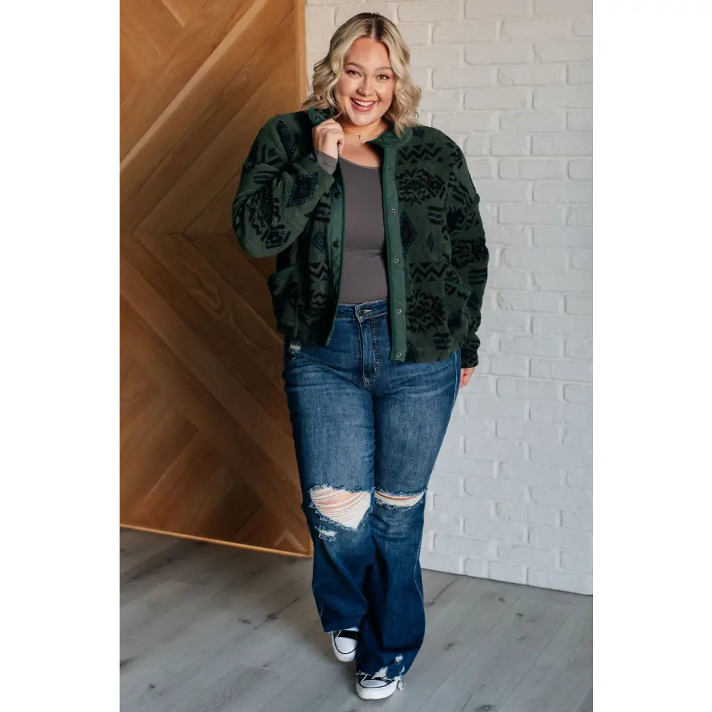 Our High Perspective Geometric Fleece Jacket! Made with green and black soft polar fleece featuring a snap front