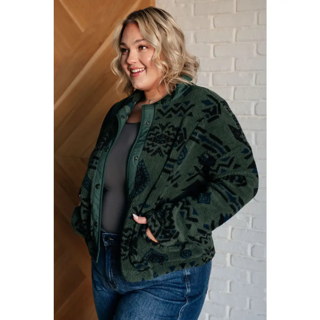 Our High Perspective Geometric Fleece Jacket! Made with green and black soft polar fleece featuring a snap front