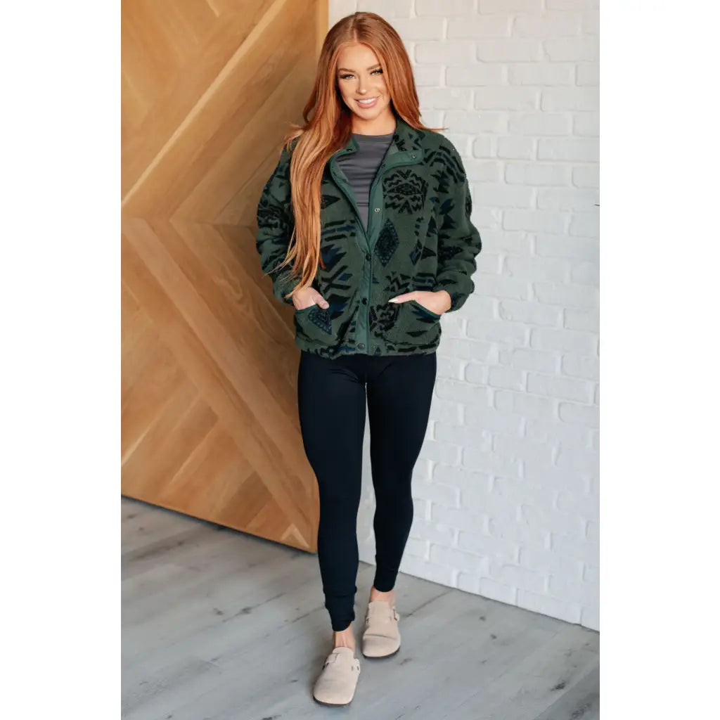 Our High Perspective Geometric Fleece Jacket! Made with green and black soft polar fleece featuring a snap front