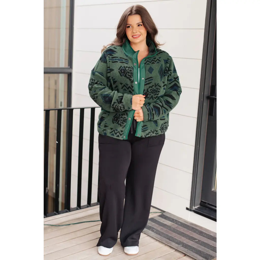 Our High Perspective Geometric Fleece Jacket! Made with green and black soft polar fleece featuring a snap front