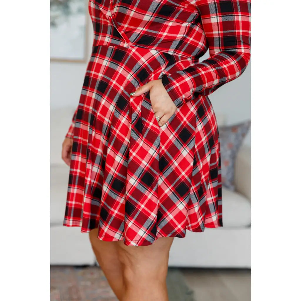 Our Highland Long Sleeve Skort Mini Dress features a faux surplice wrap front long sleeves and red tartan plaid