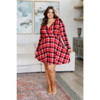 Our Highland Long Sleeve Skort Mini Dress features a faux surplice wrap front long sleeves and red tartan plaid