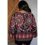 Our I Feel That Peasant Blouse is beautifully textured with a lightweight woven black fabric features tie-neck keyhole