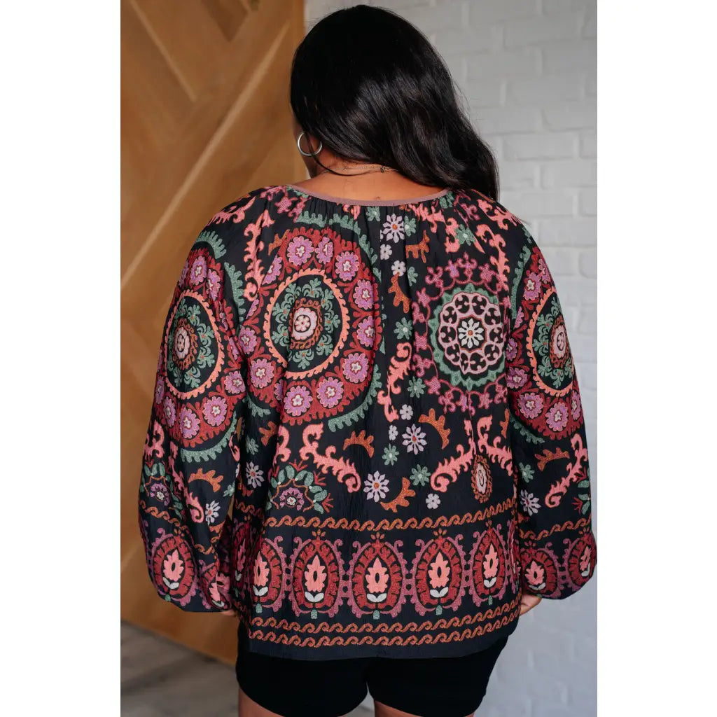 Our I Feel That Peasant Blouse is beautifully textured with a lightweight woven black fabric features tie-neck keyhole